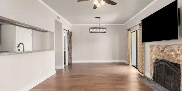 Image 3: Spacious living area with elegant hardwood floorin