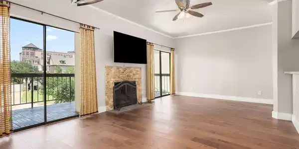 Image 4: Spacious living area featuring elegant hardwood fl
