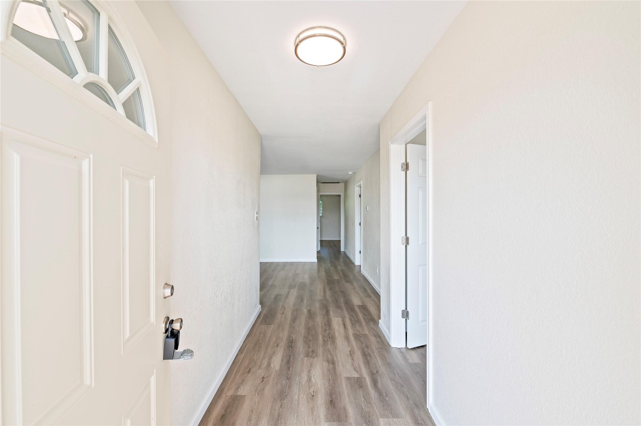 Image 4: Front door opens up to entryway hallway and views