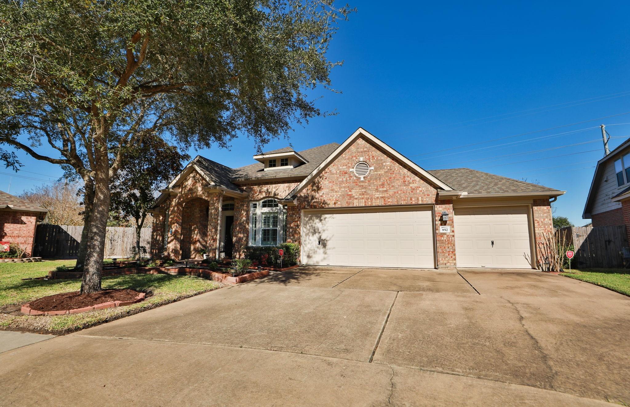 Image 3: Nestled amidst lush greenery, this inviting home f