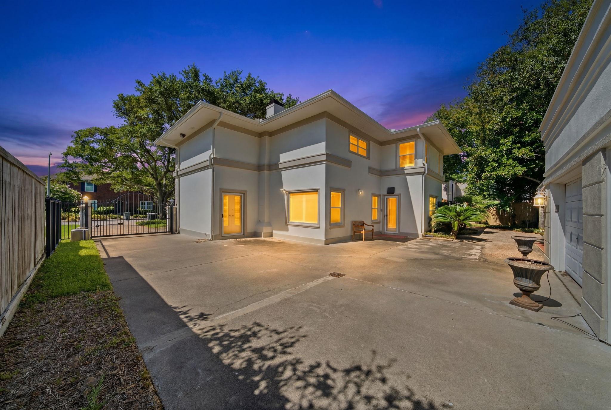 Image 3: View from garage and driveway to back of the house