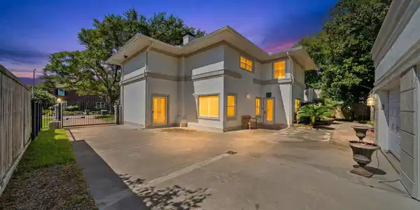 Image 3: View from garage and driveway to back of the house