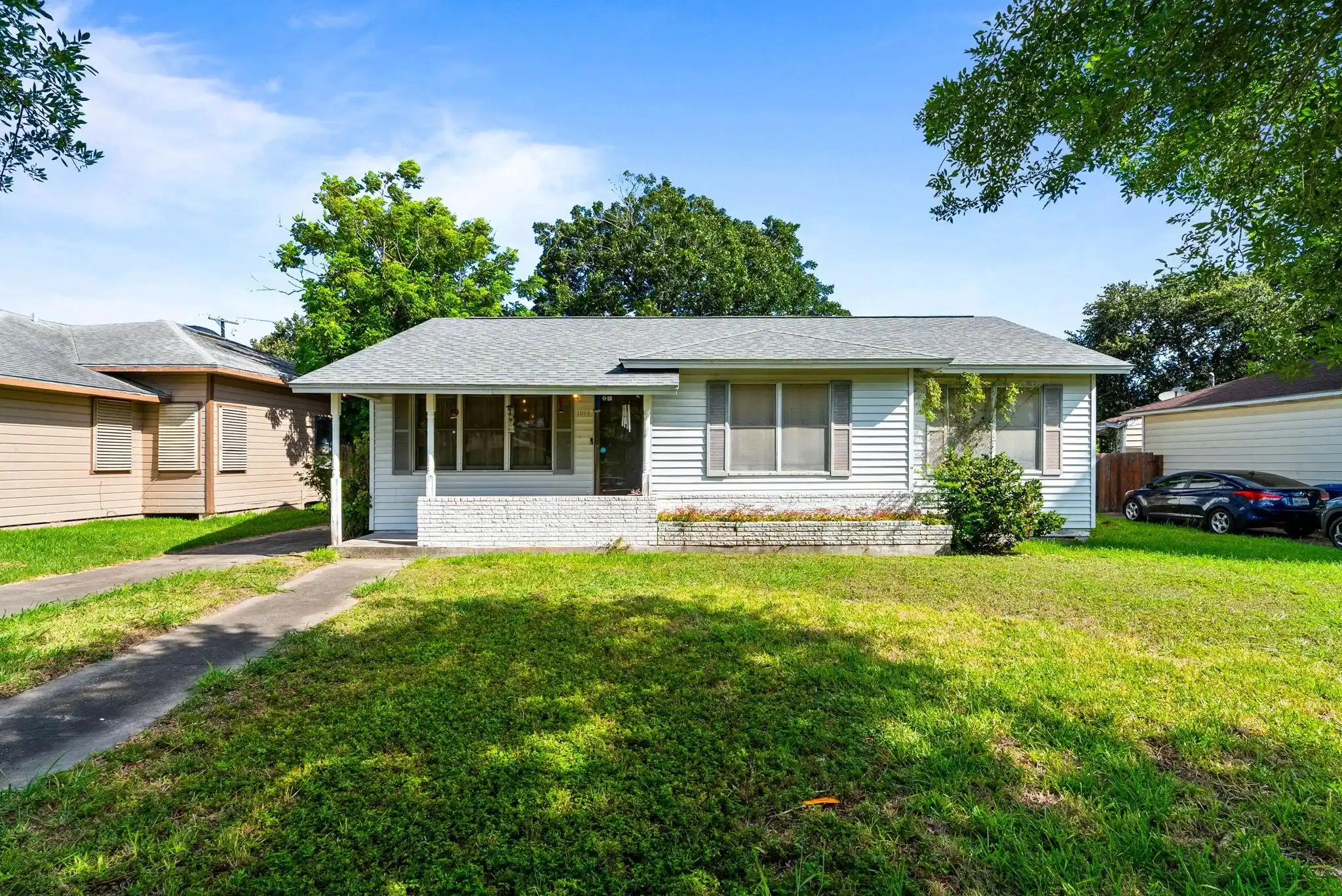 Image 1: Front exterior view of the single-story home featu