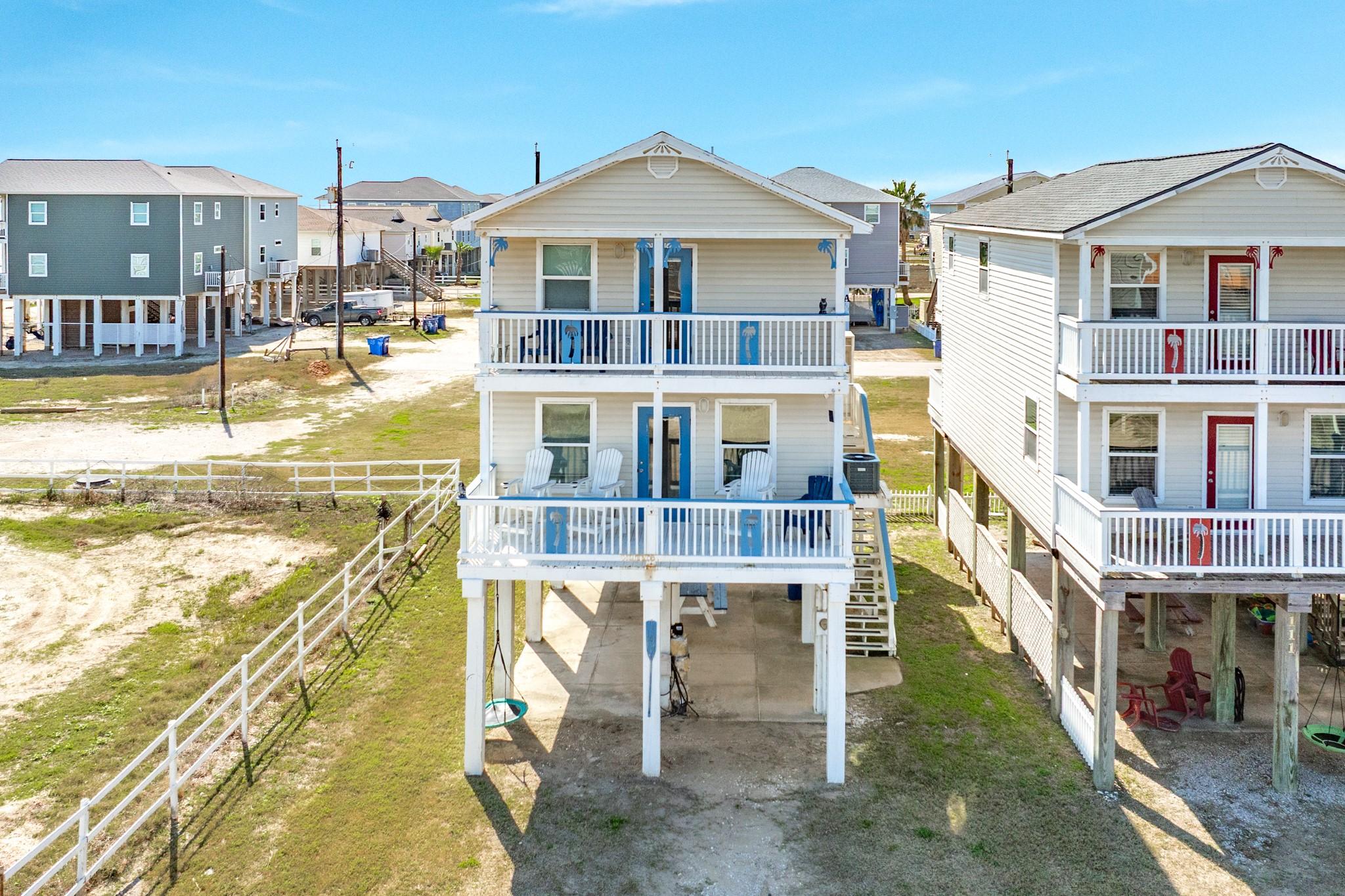 Image 2: Elevated coastal home with dual covered balconies,