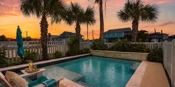 Image 2: Poolside view highlighting the elevated home, shad