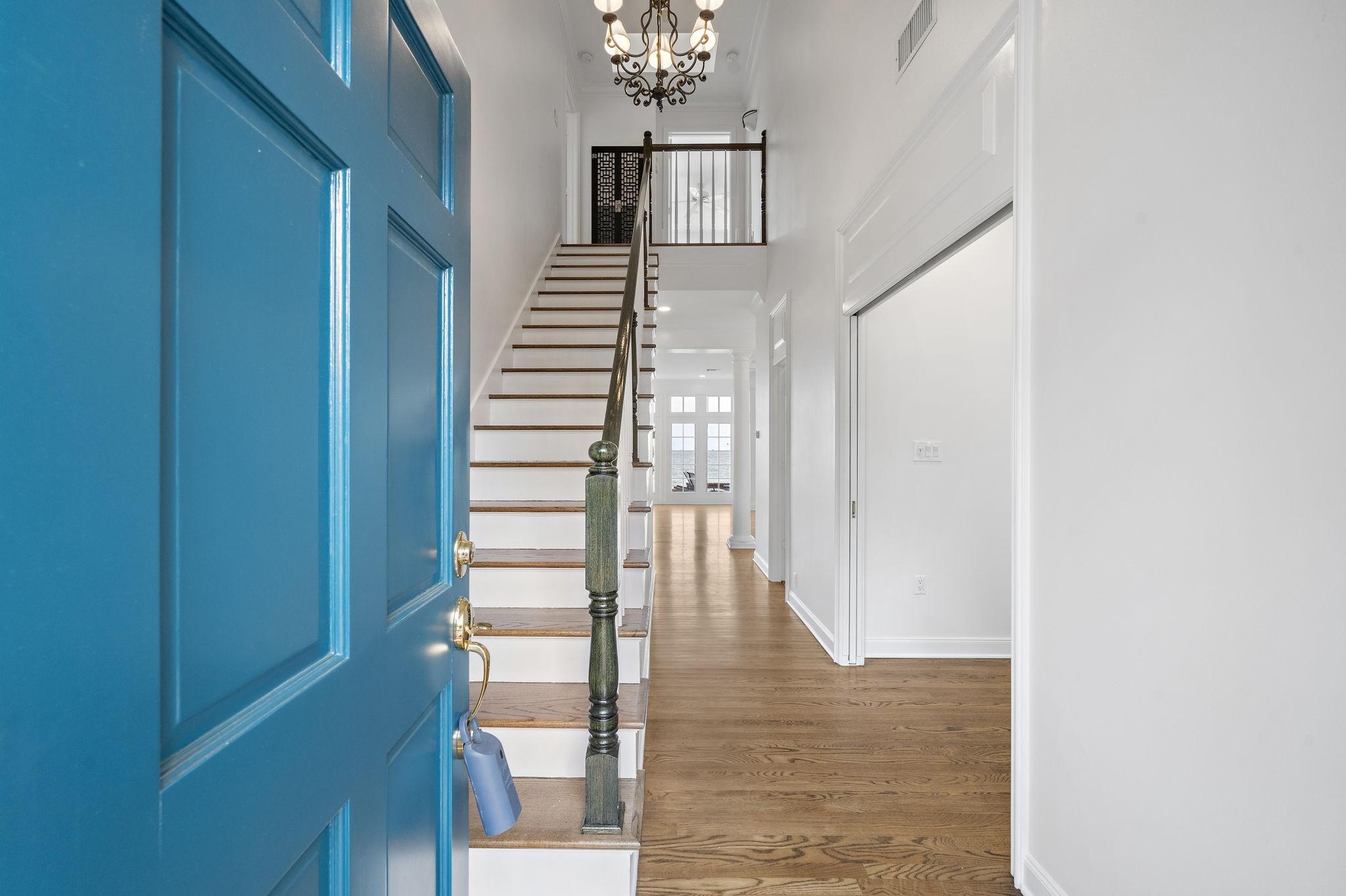 Image 3: Two story foyer and hallway leading to the living