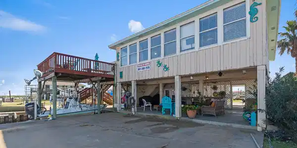 Image 2: Home features a large concrete covered patio, a hu