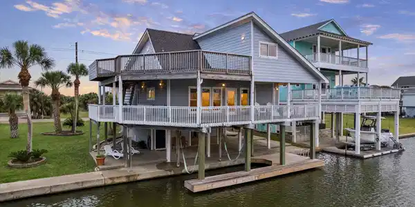 Image 2: Stunning waterfront home with expansive wrap-aroun