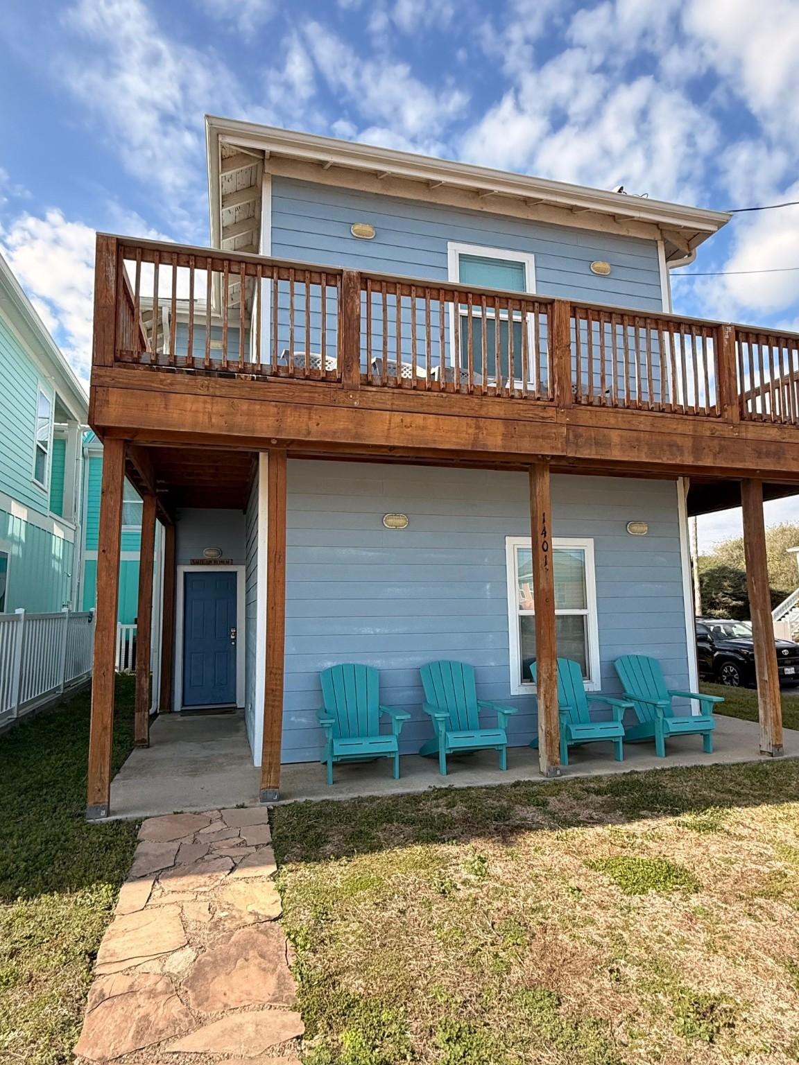 Image 3: This charming two-story home features a light blue
