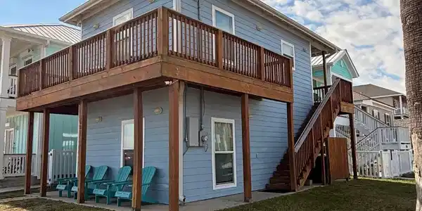 Image 4: This is a charming two-story coastal home with a s
