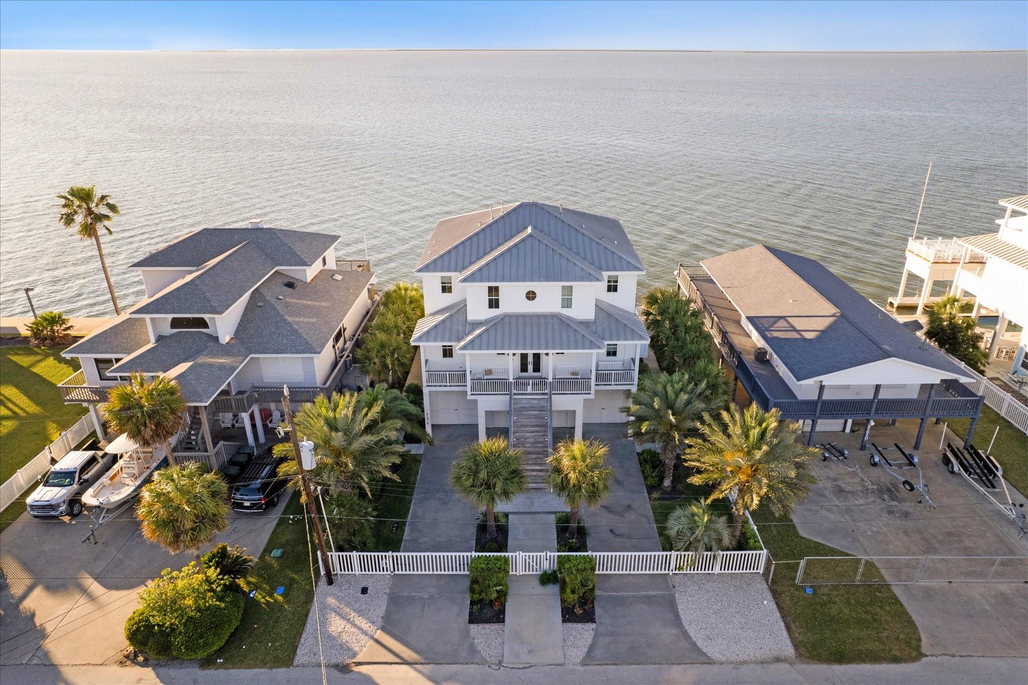 Image 4: Welcome home to this stunning bayfront retreat fea
