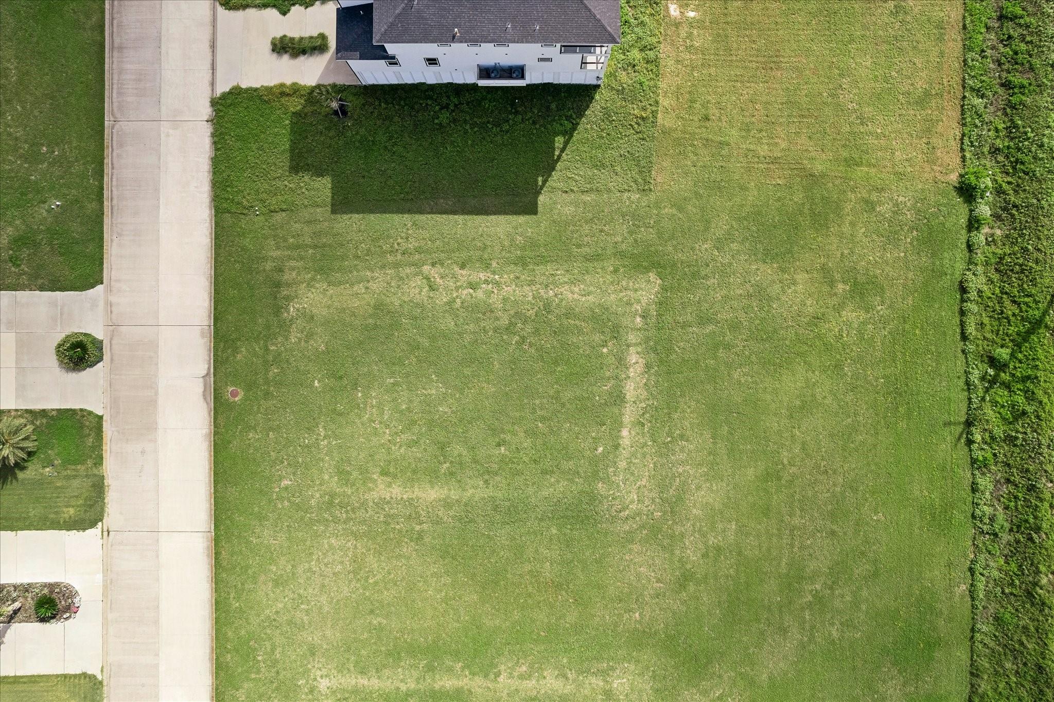 Image 3: Cleared and level from above, the lot offers a cle