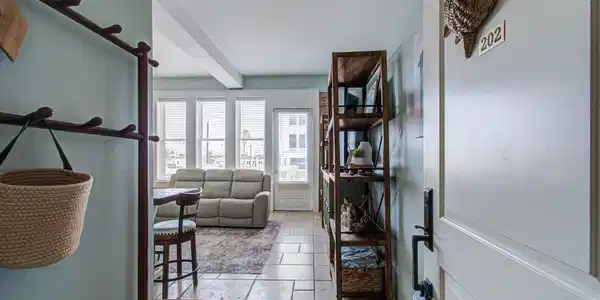 Image 4: Entryway leading to a cozy living room with large