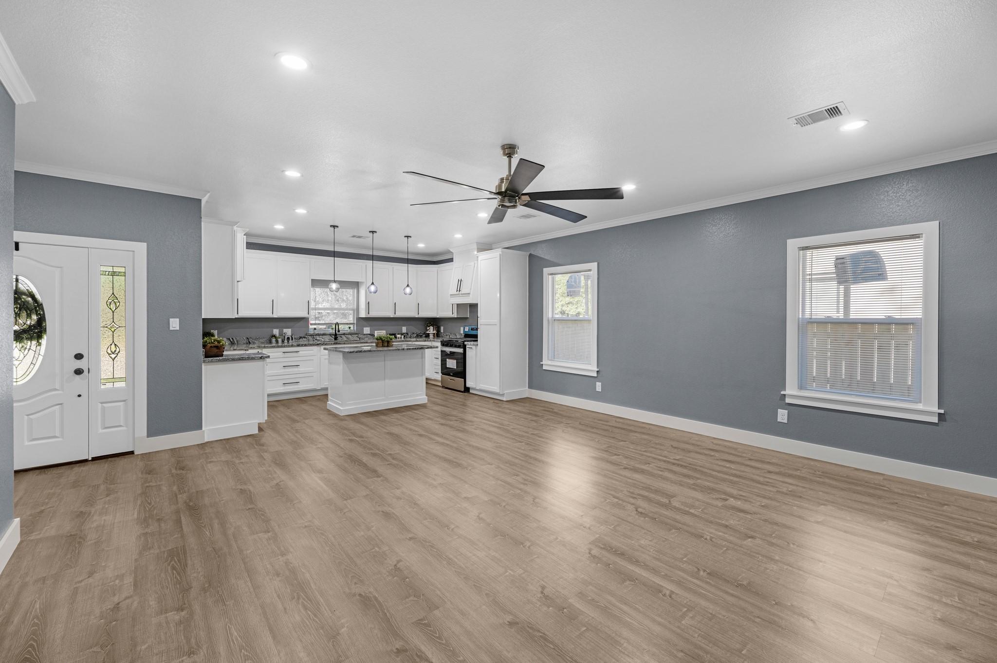 Image 4: As you enter, you are greeted with an open floor p