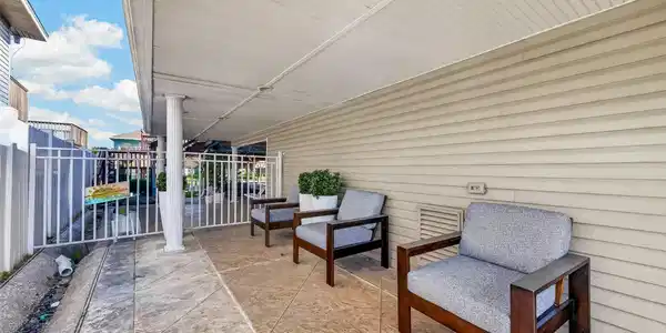 Image 4: A shaded patio nestled beside the garage&mdash;providing
