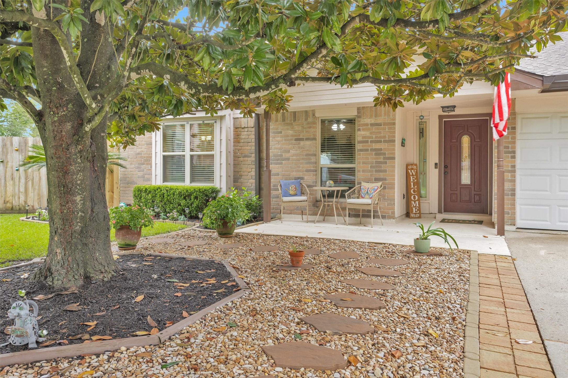 Image 2: A welcoming Front Porch shaded by a mature Magnoli