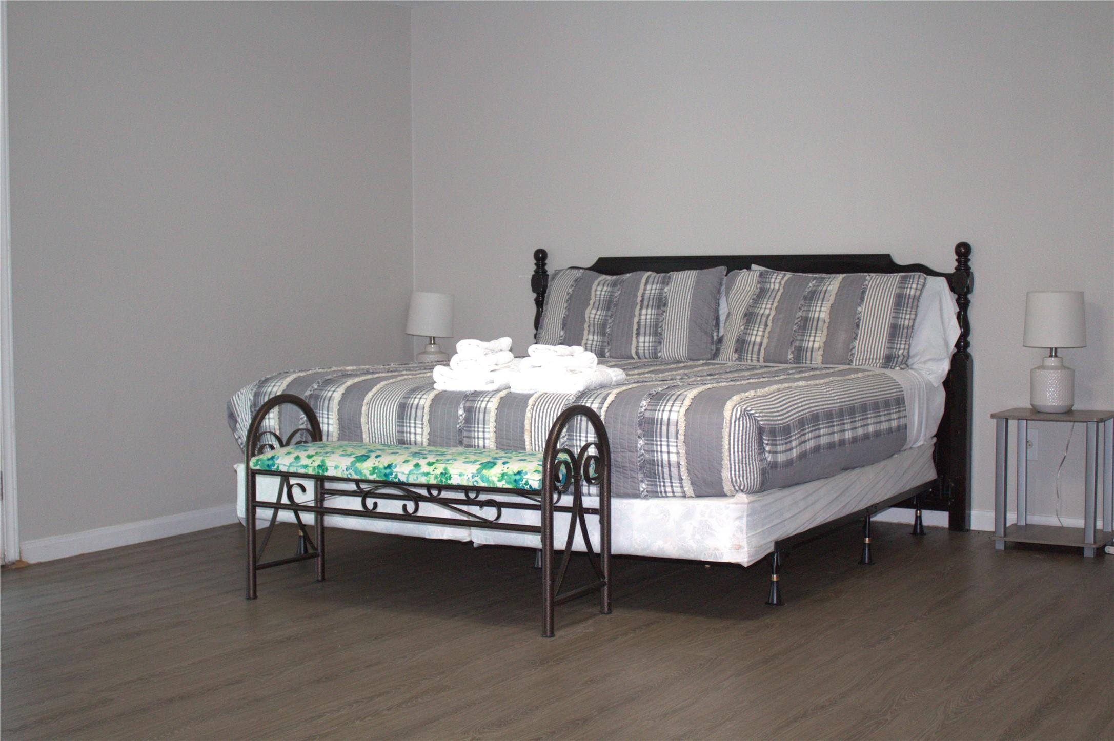 Image 4: primary bedroom with bed and nightstand