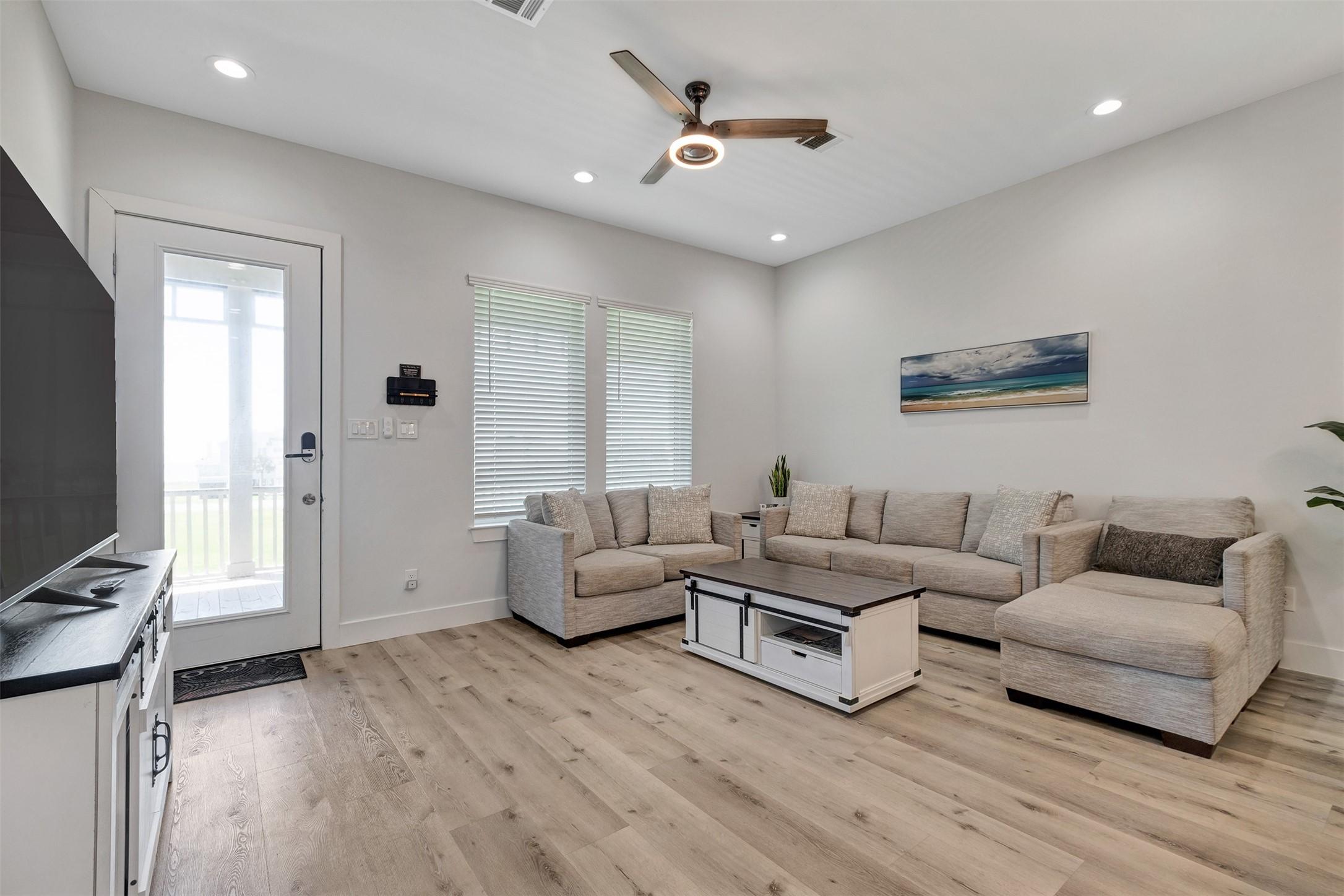 Image 4: The front entryway opens onto a relaxing deck with