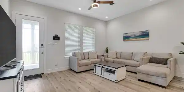 Image 4: The front entryway opens onto a relaxing deck with