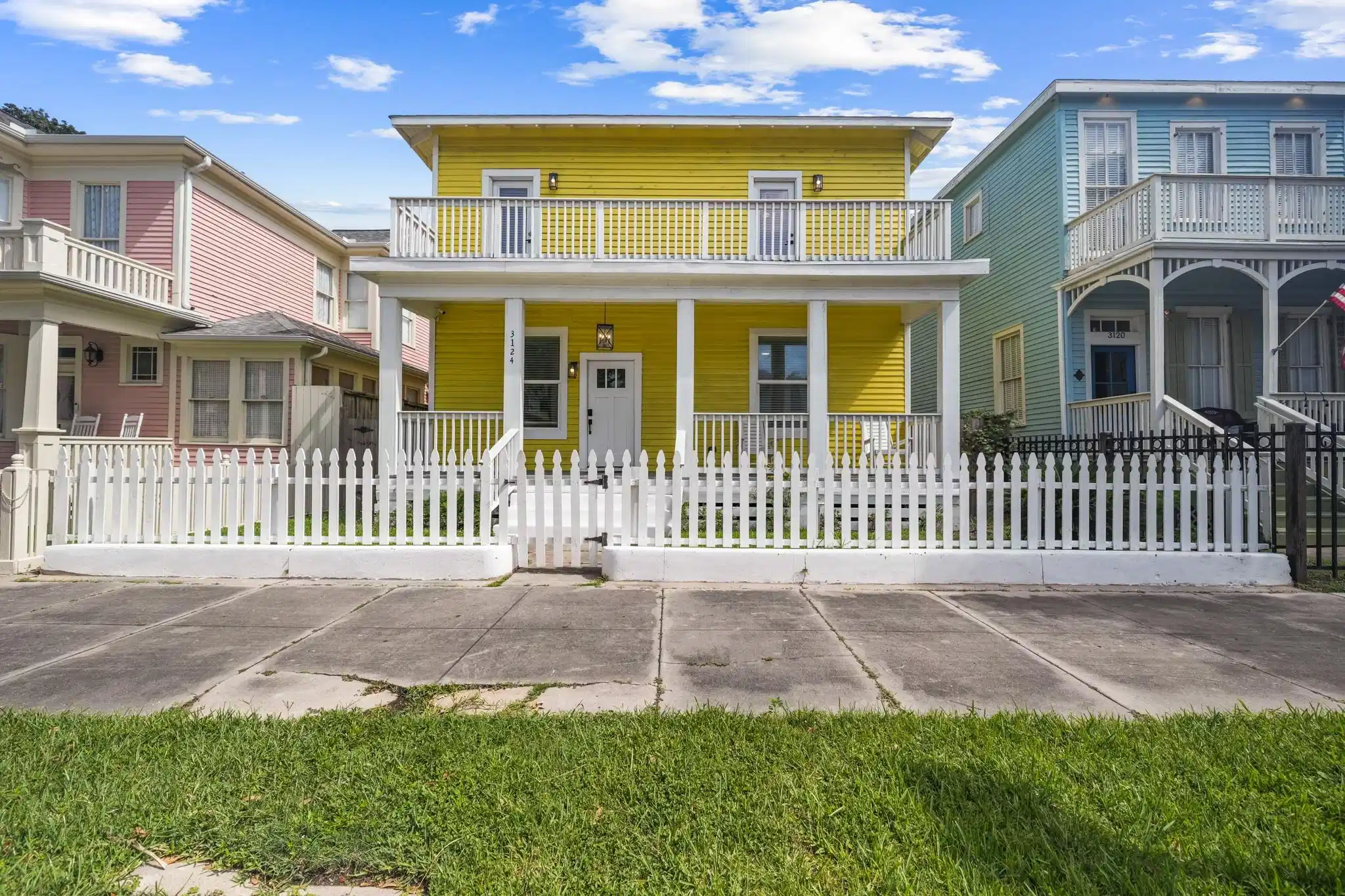 Image 1: Charming two-story yellow home with a welcoming fr