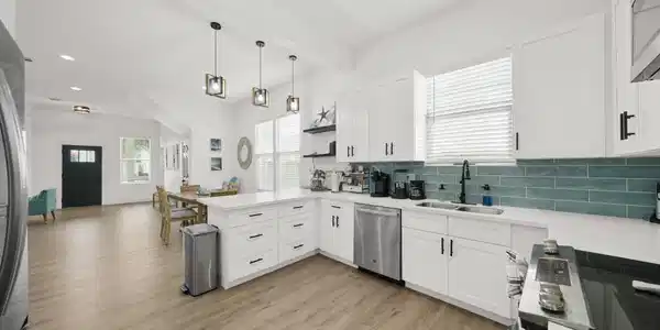 Image 3: Bright and spacious kitchen featuring modern white