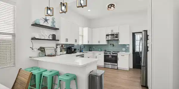Image 4: Bright and modern kitchen featuring sleek white ca