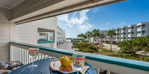 Image 2: Private covered balcony with a coastal-inspired se