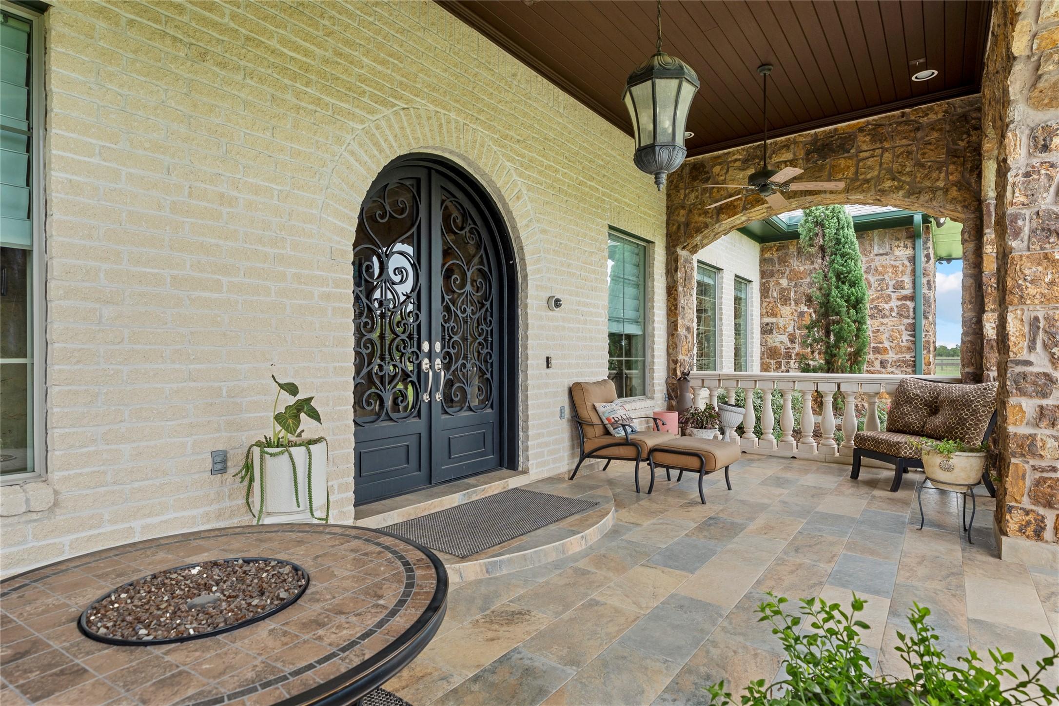 Image 2: Large arched iron front door.