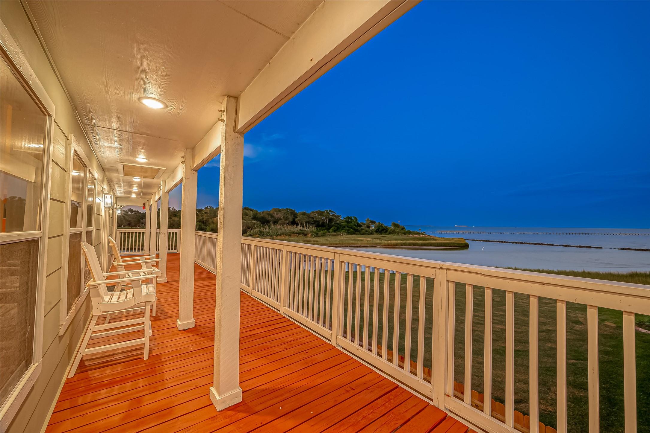 Image 1: Covered wraparound deck offers the perfect setting