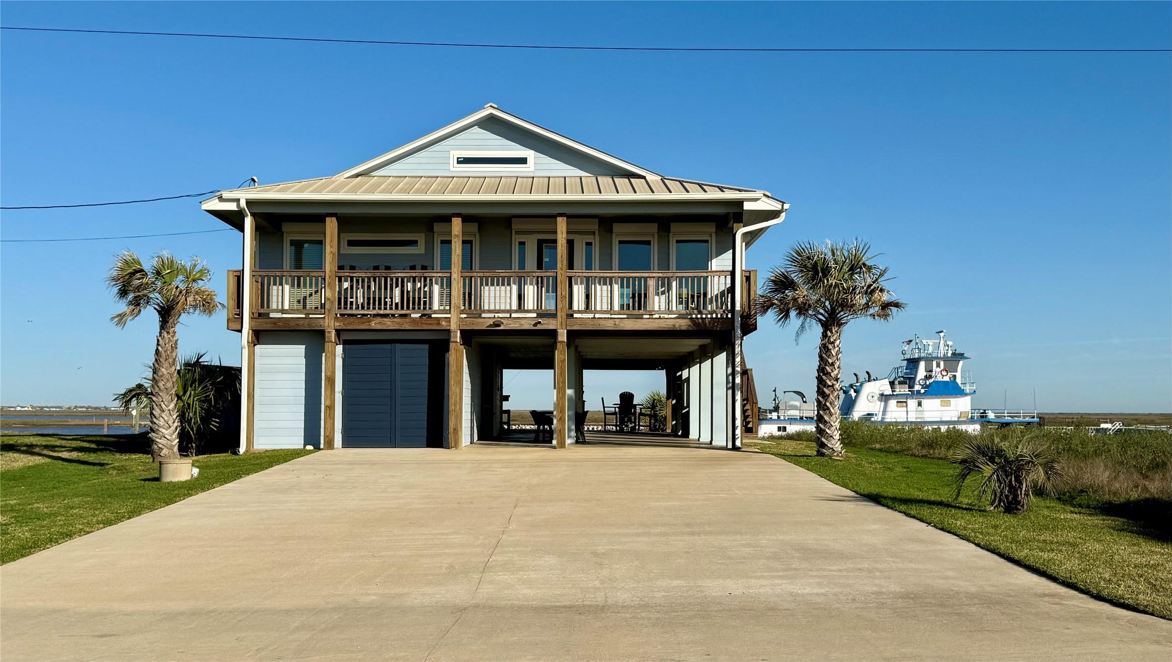 Image 2: Elevated coastal home with spacious decks front an