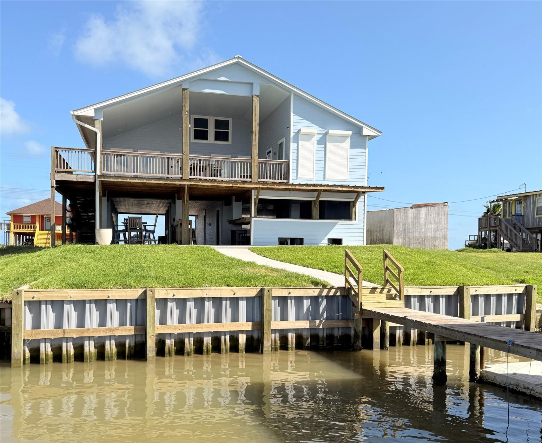 Image 3: This waterfront home features a spacious design wi