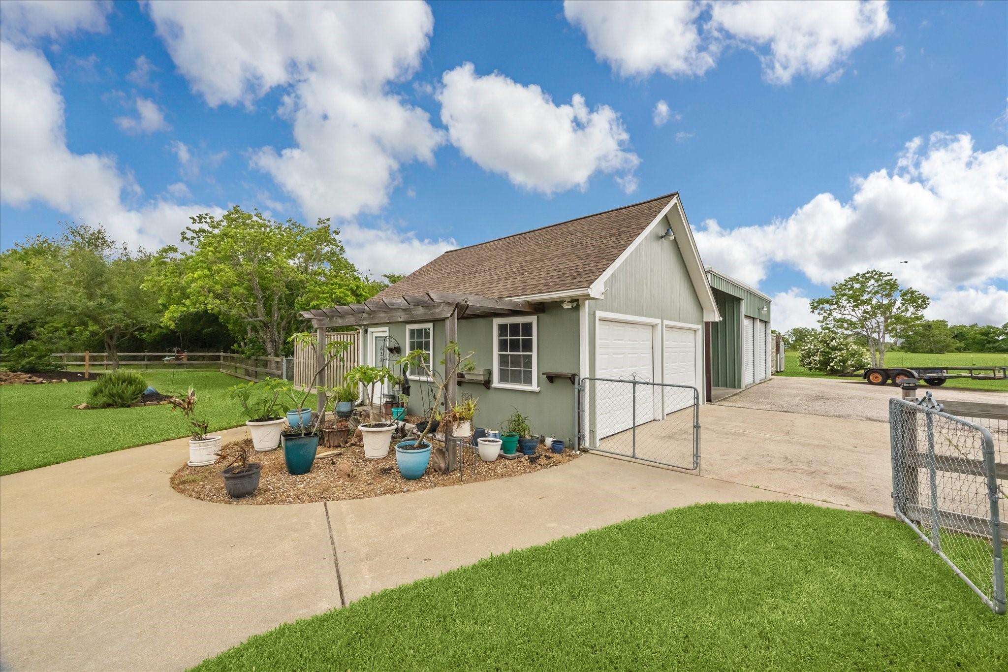 Image 3: view of side of garage, boat/RV carport & sheds