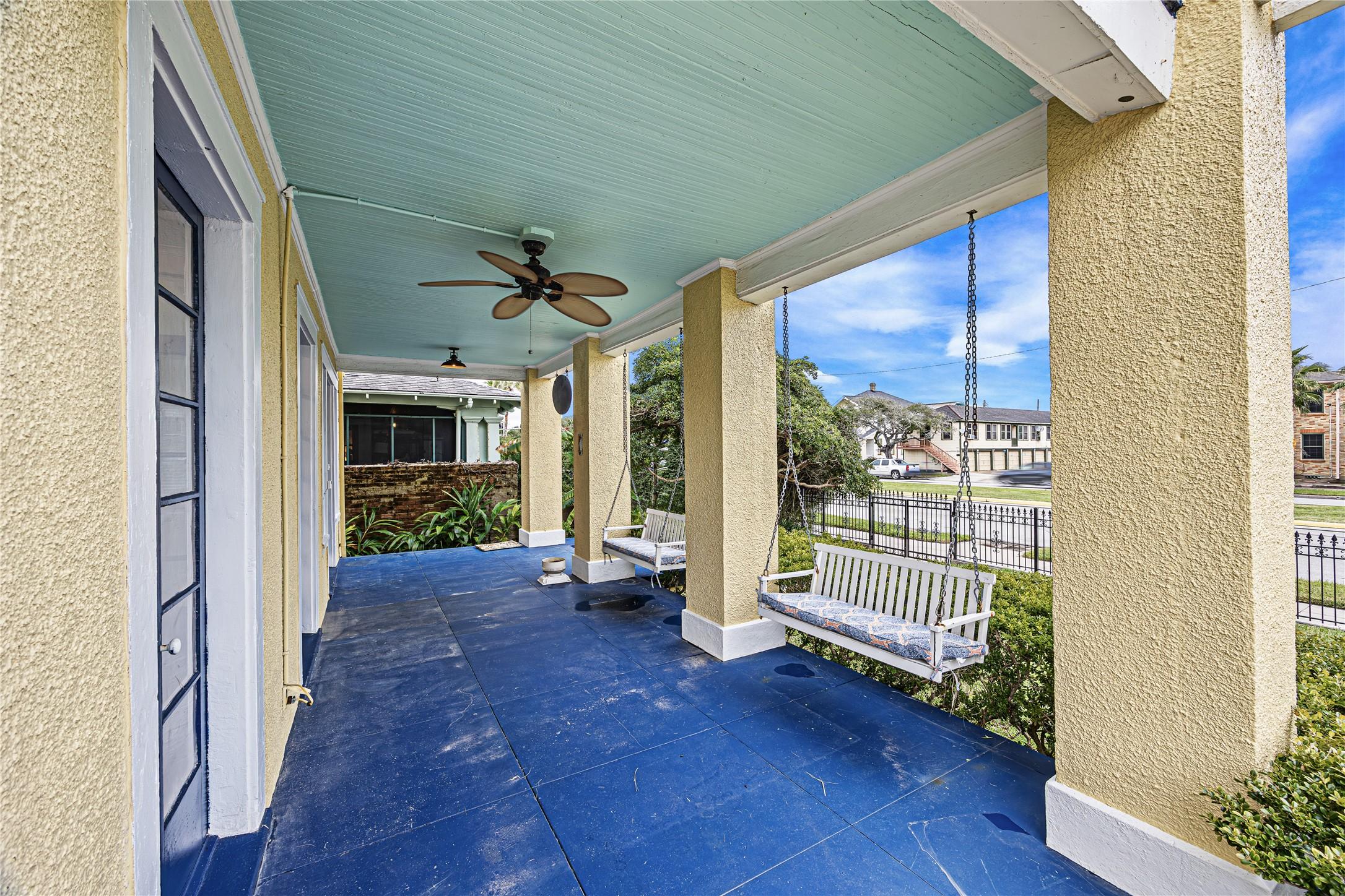 Image 3: Charming covered front porch with a ceiling fan an