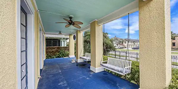 Image 3: Charming covered front porch with a ceiling fan an