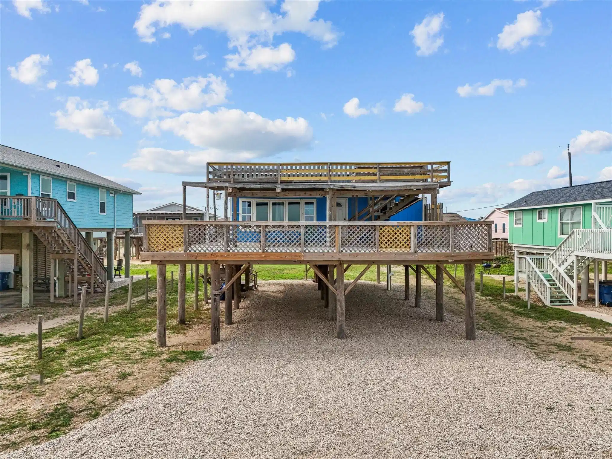 Image 1: Elevated beach house with large deck and rooftop d