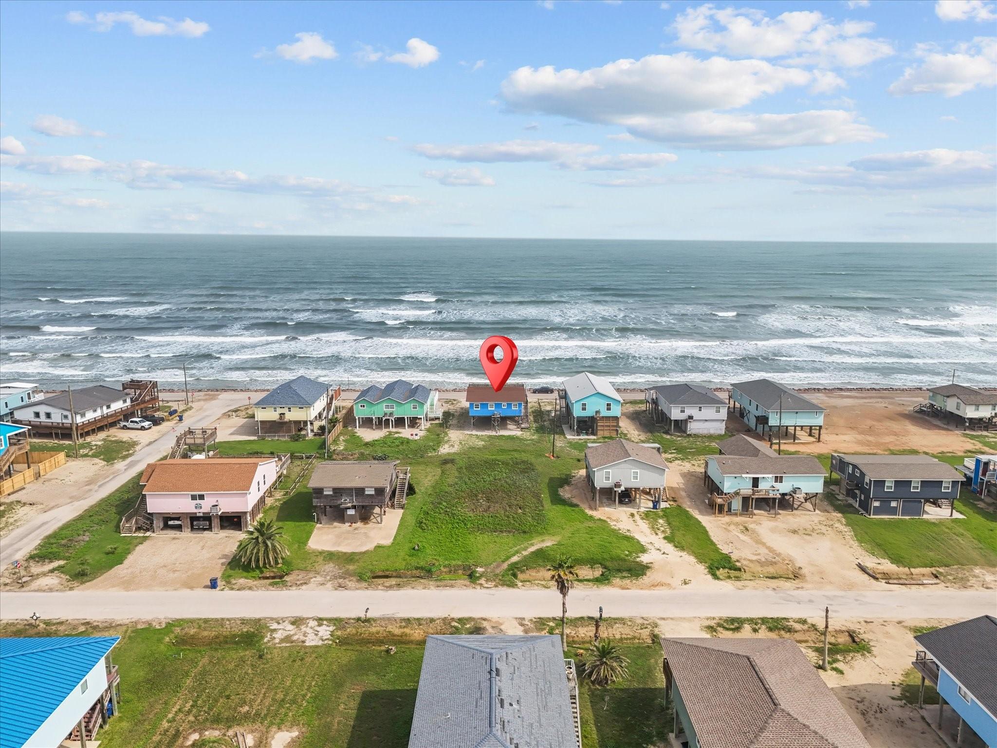 Image 2: This aerial photo showcases a beachfront property
