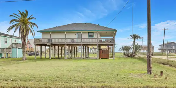 Image 2: This view of the rear of the house is from Surf St