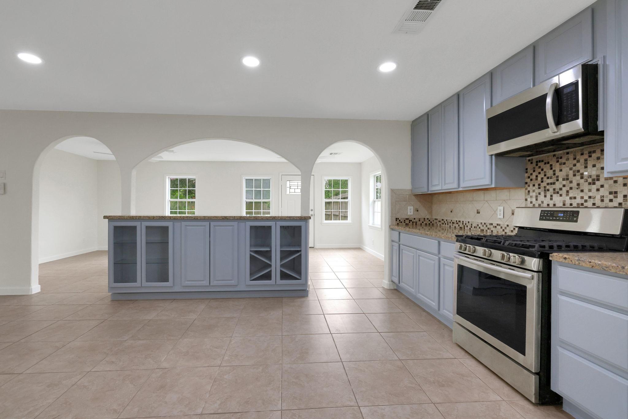 Image 4: This spacious kitchen features modern stainless st