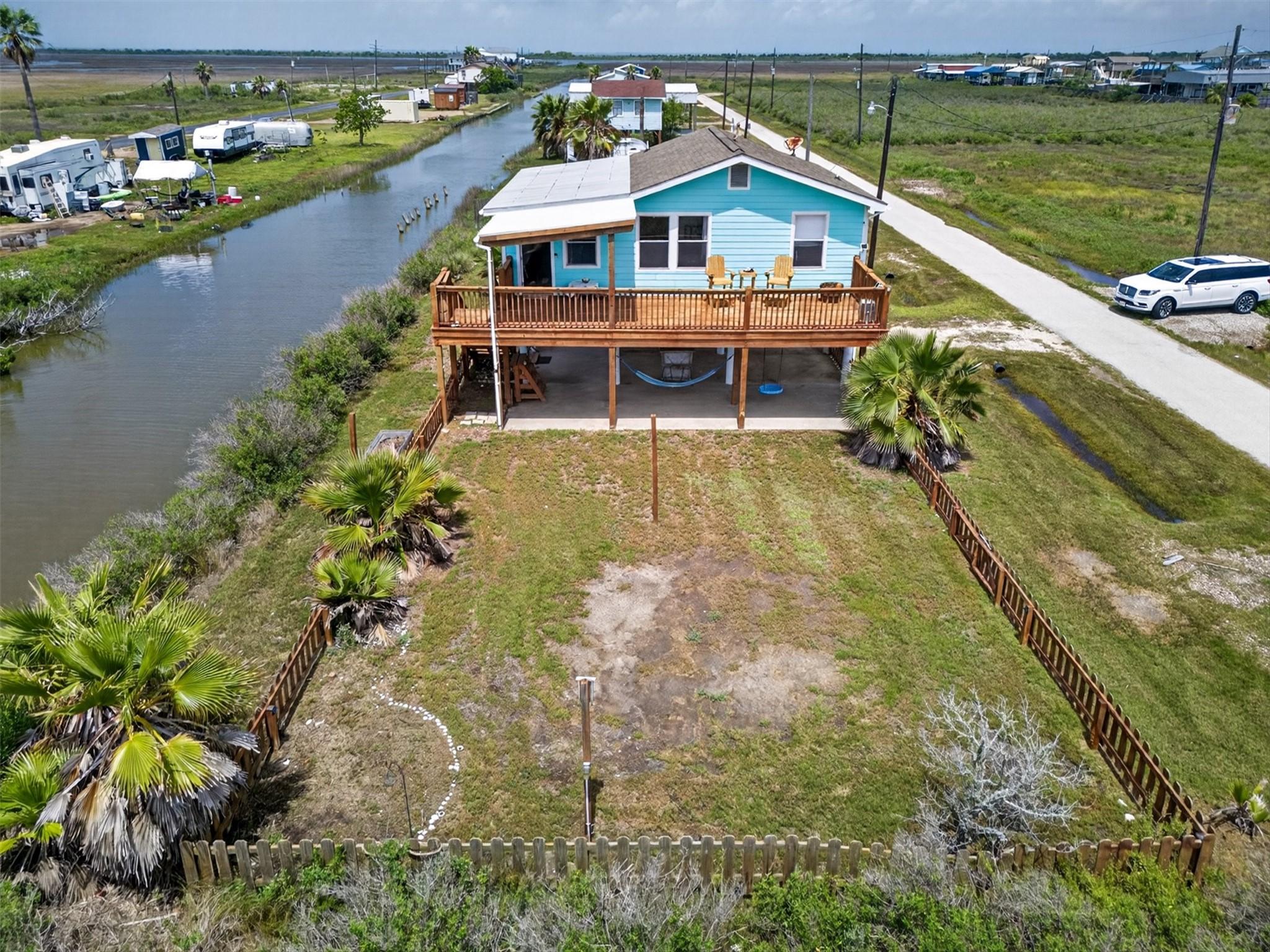 Image 2: Front aerial showcasing canal-front positioning, f
