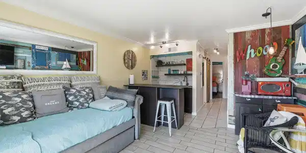 Image 3: This cozy living space features a bright, open lay