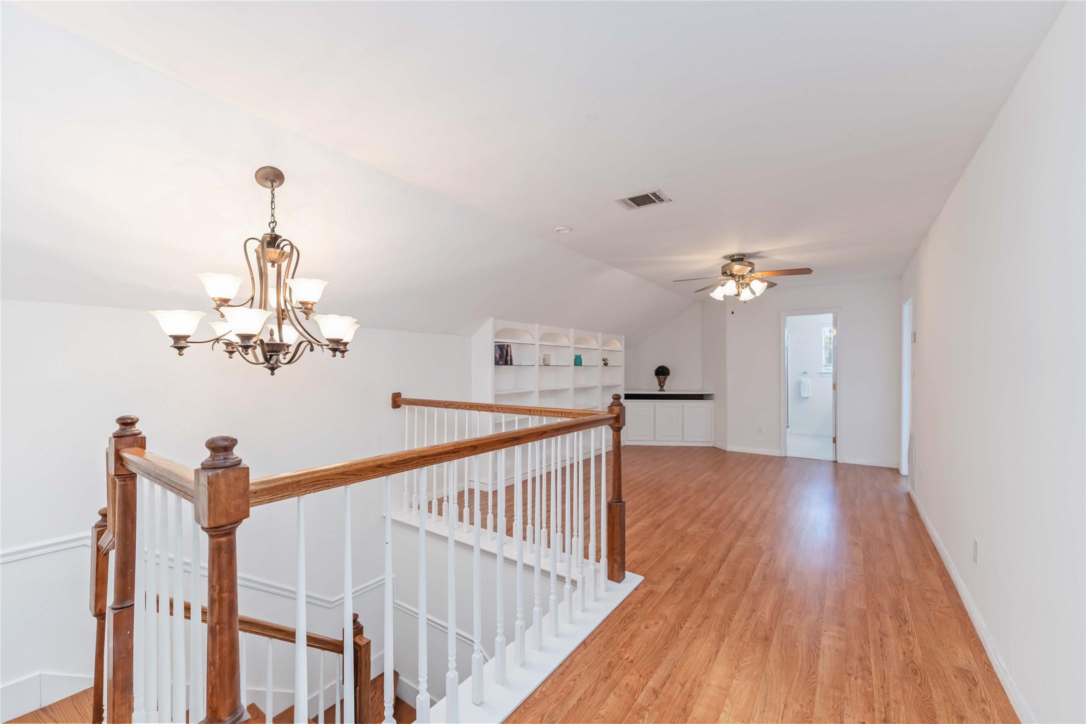 Image 2: This photo showcases a bright, open upstairs landi