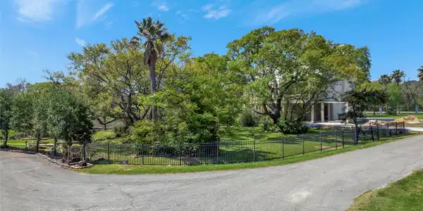Image 3: Mature trees frame this exceptional homesite.