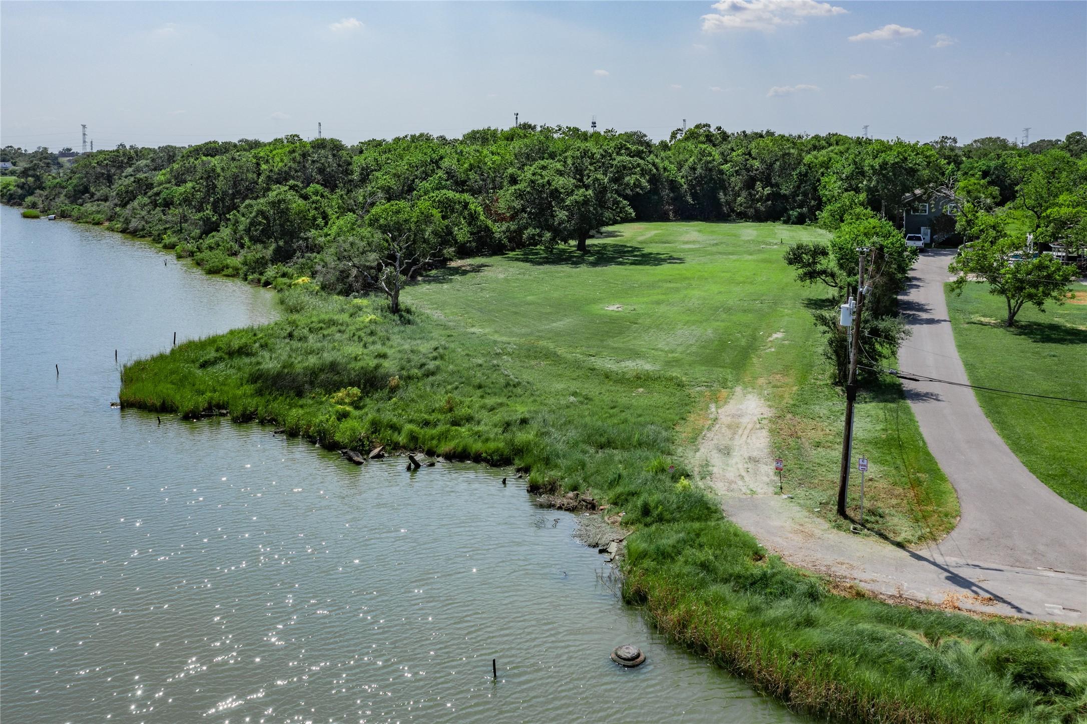Image 4: A serene waterfront property with lush greenery, a