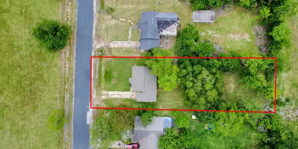 Image 2: Aerial view of the property, notice home sits on a