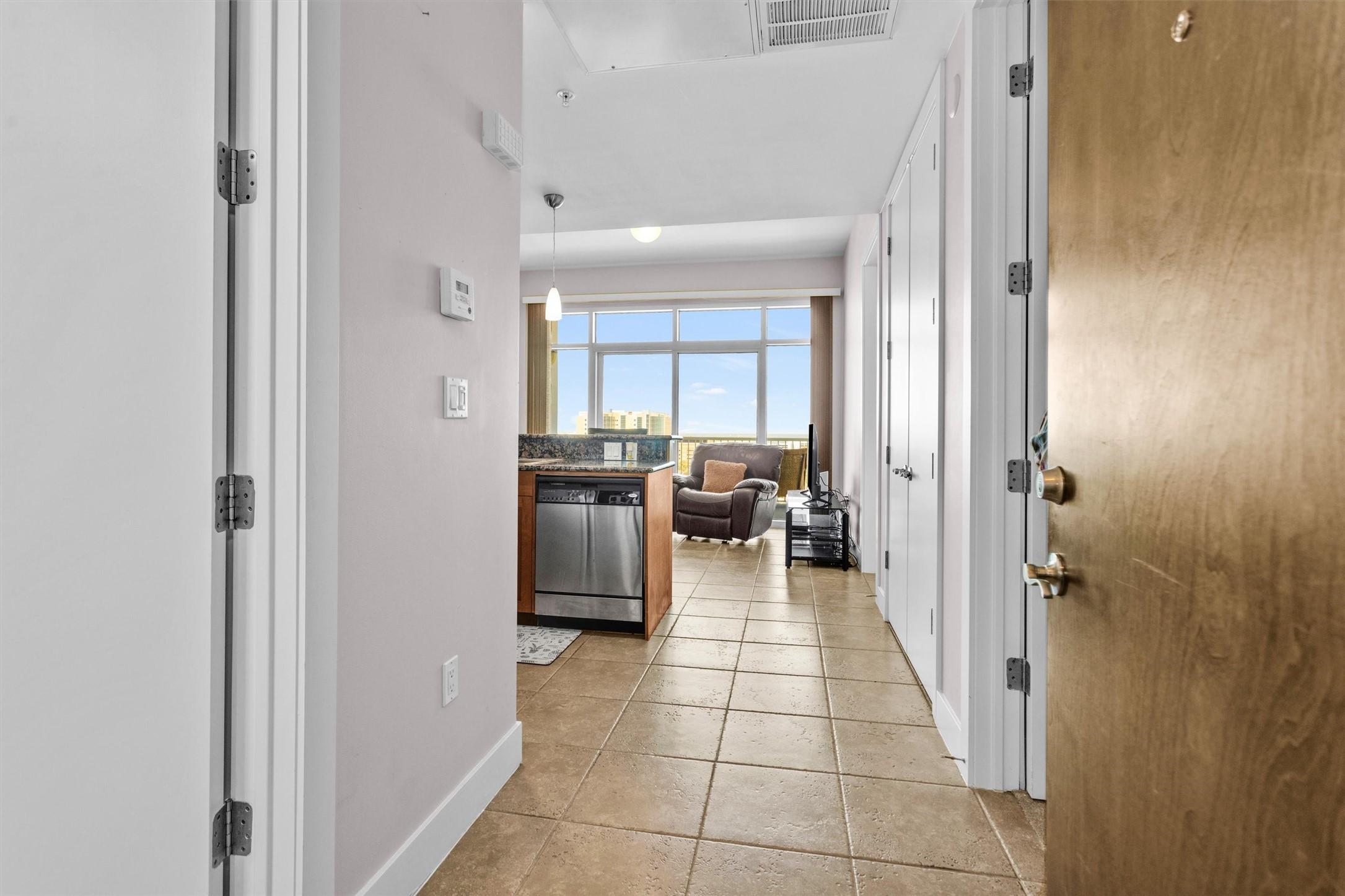 Image 2: Entry hallway leading into kitchen and living area
