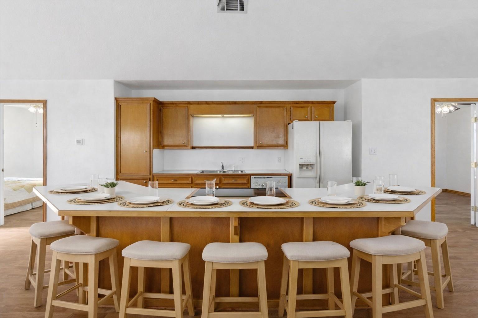 Image 4: The kitchen has a clean and simple design. The isl