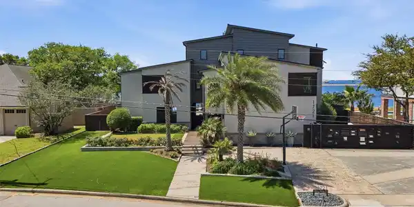 Image 2: Striking front yard featuring a putting green, bea