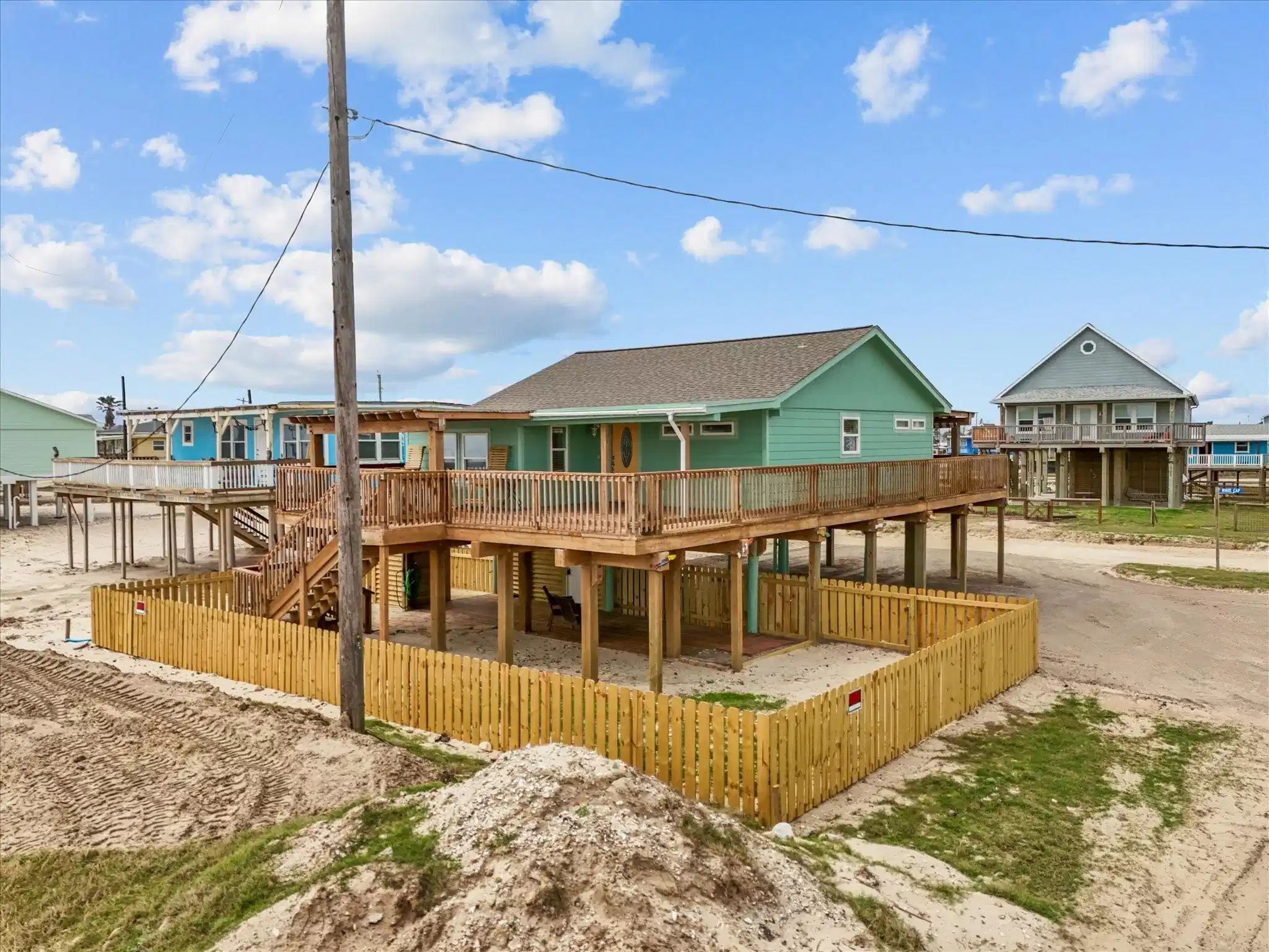 Image 1: This is a raised beach house with a spacious wrap-