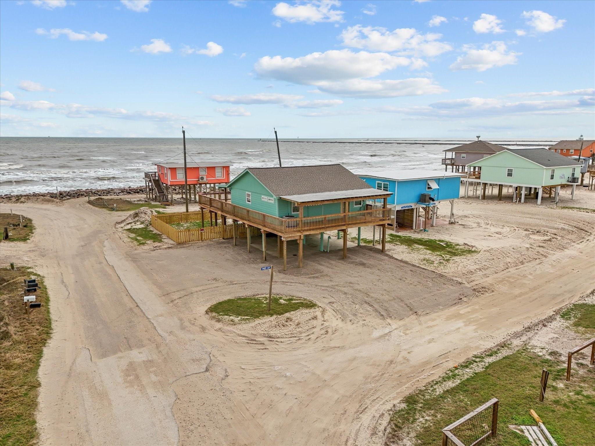 Image 2: Elevated beachfront home with vibrant colors, offe