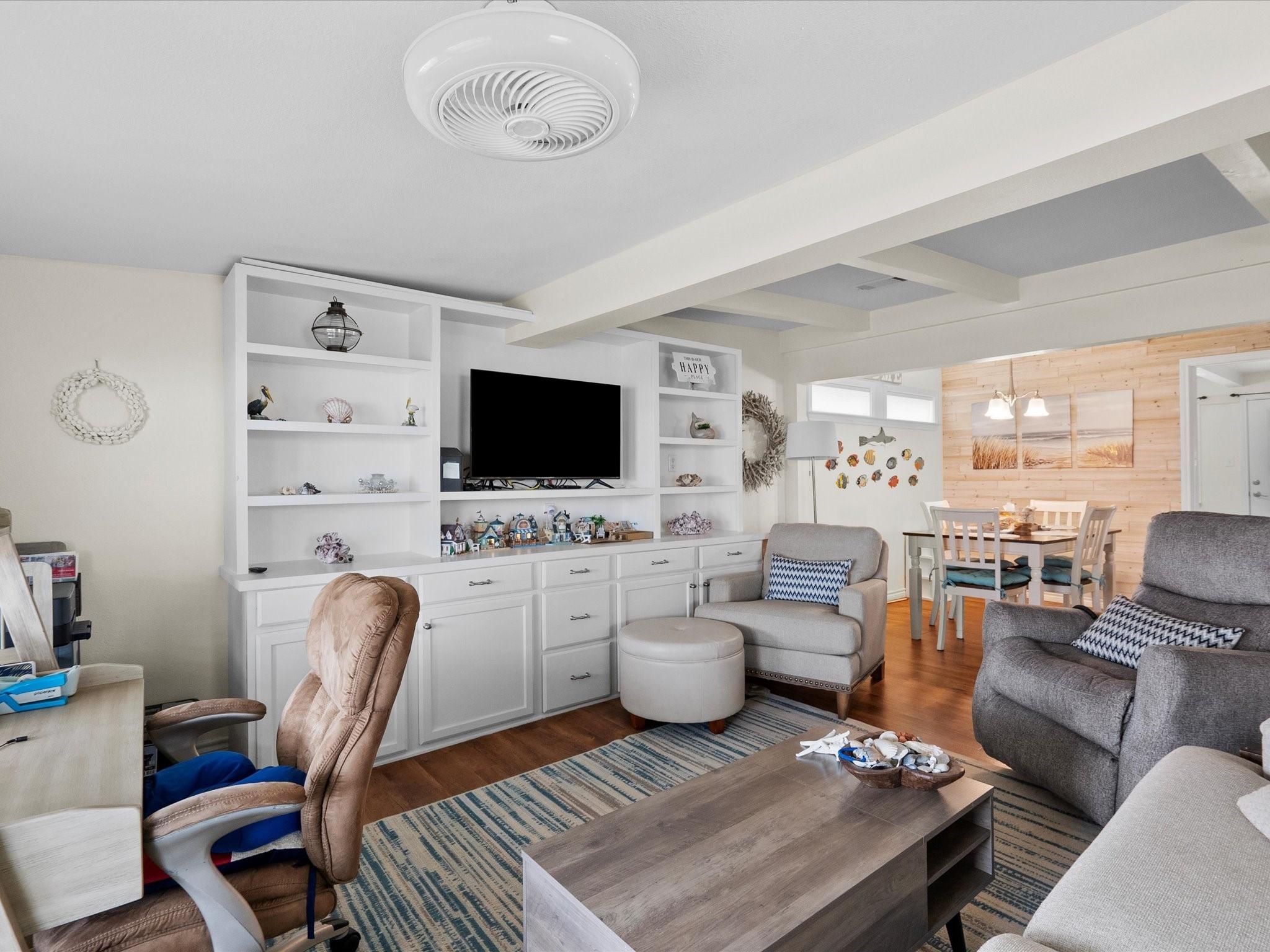 Image 3: This cozy living room features built-in white shel